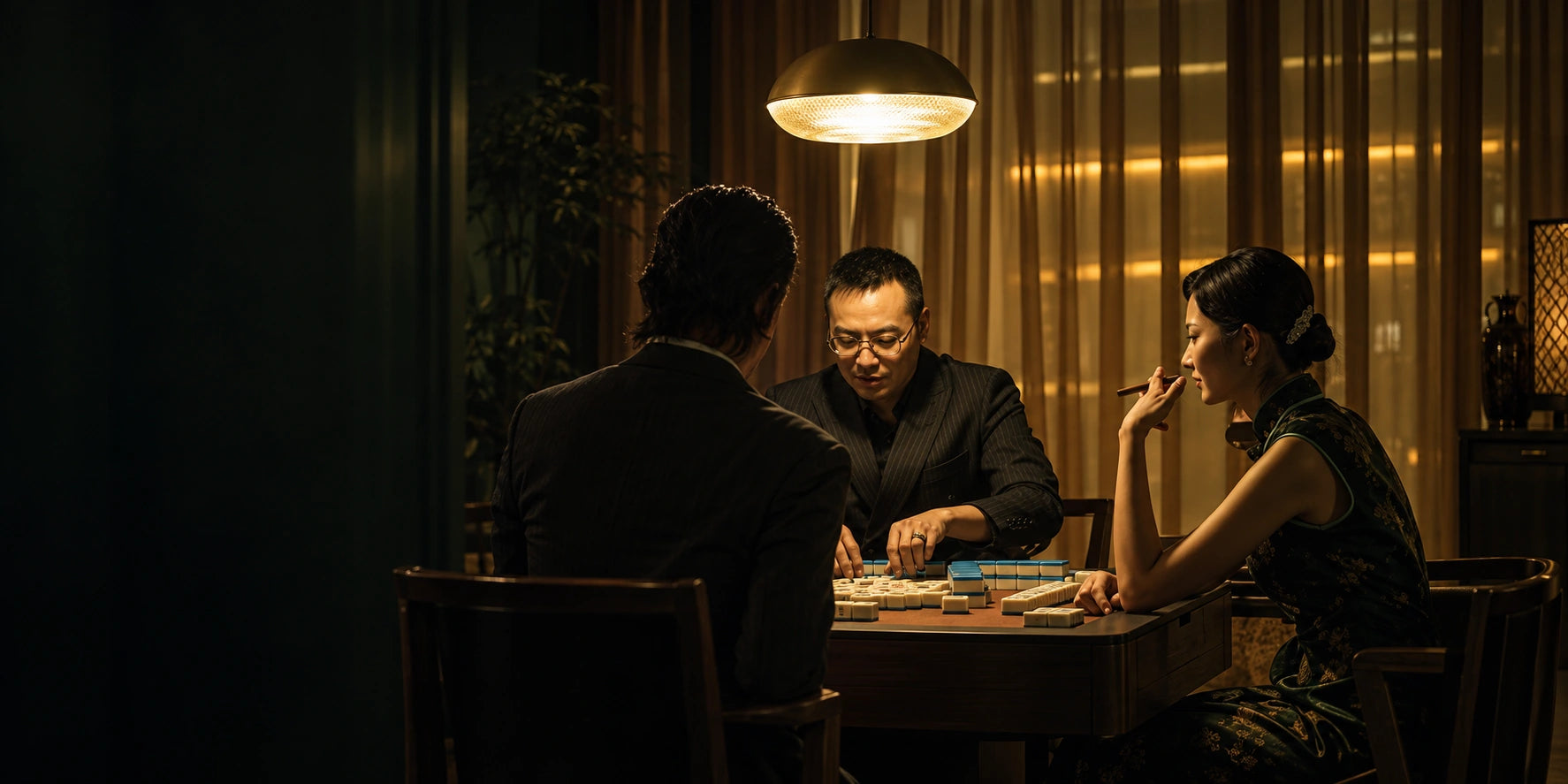 Friends gathered at a warmly lit Mahjong table